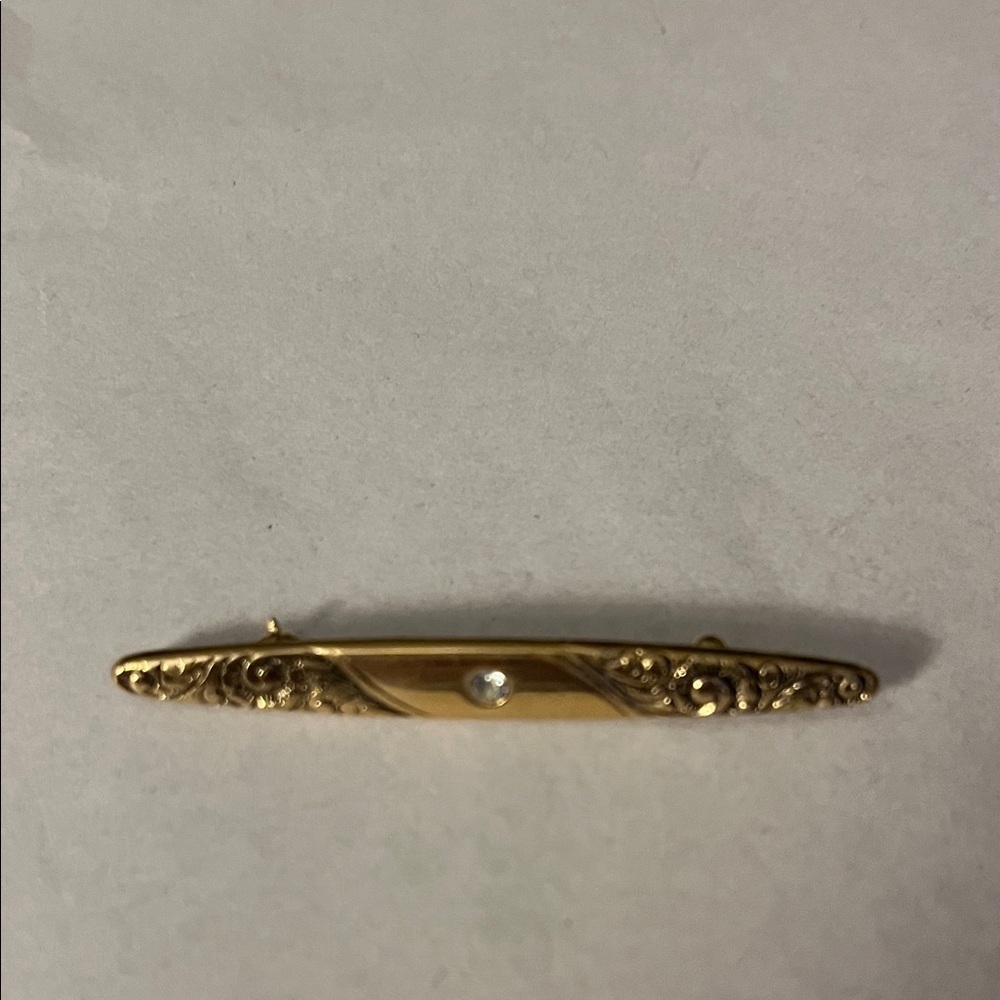 Avon gold tone Victorian style scroll brooch pin.